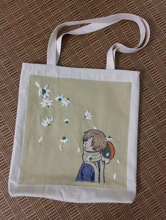 Hand-printed cotton tote bag carried over shoulder in casual city walk