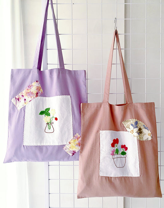 Embroidered and patchwork cotton tote bags displayed as sustainable party favors