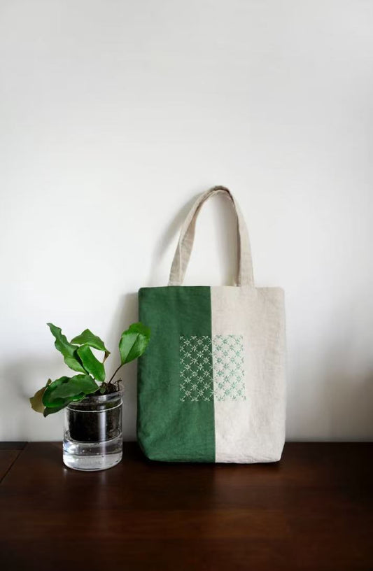 Eco-conscious woman holding a sustainable fabric tote bag on a city street