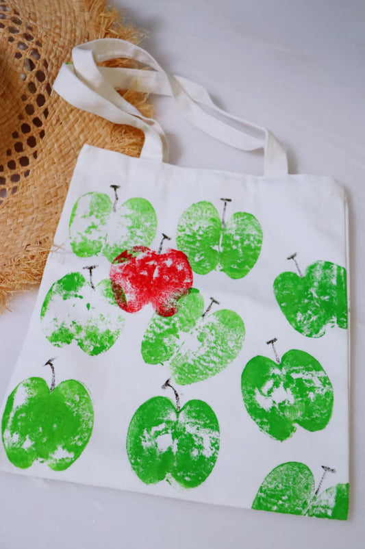 Minimalist living setup with a hand-embroidered tote bag and organized kitchen essentials