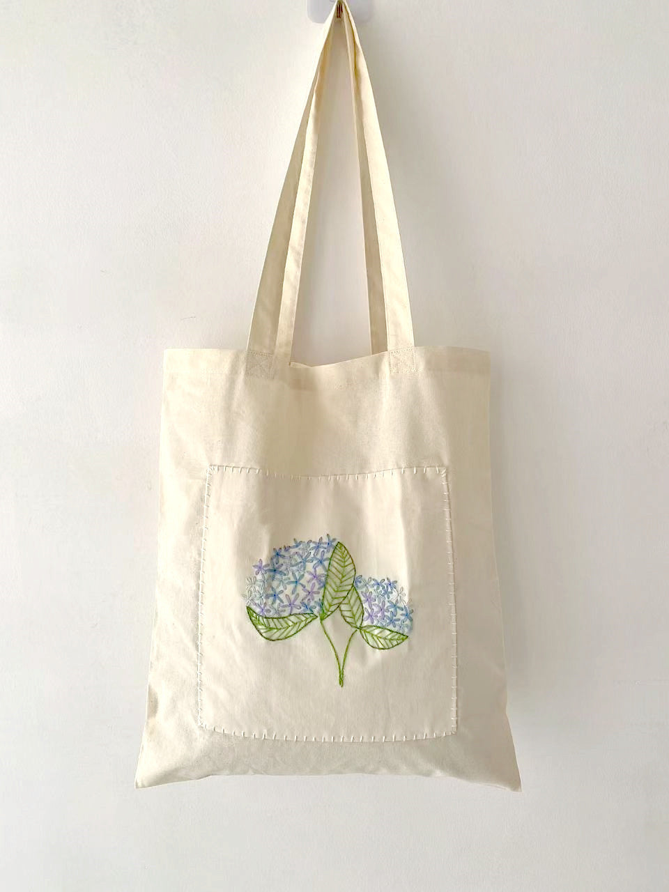 Durable cotton tote with hand-stitched flowers