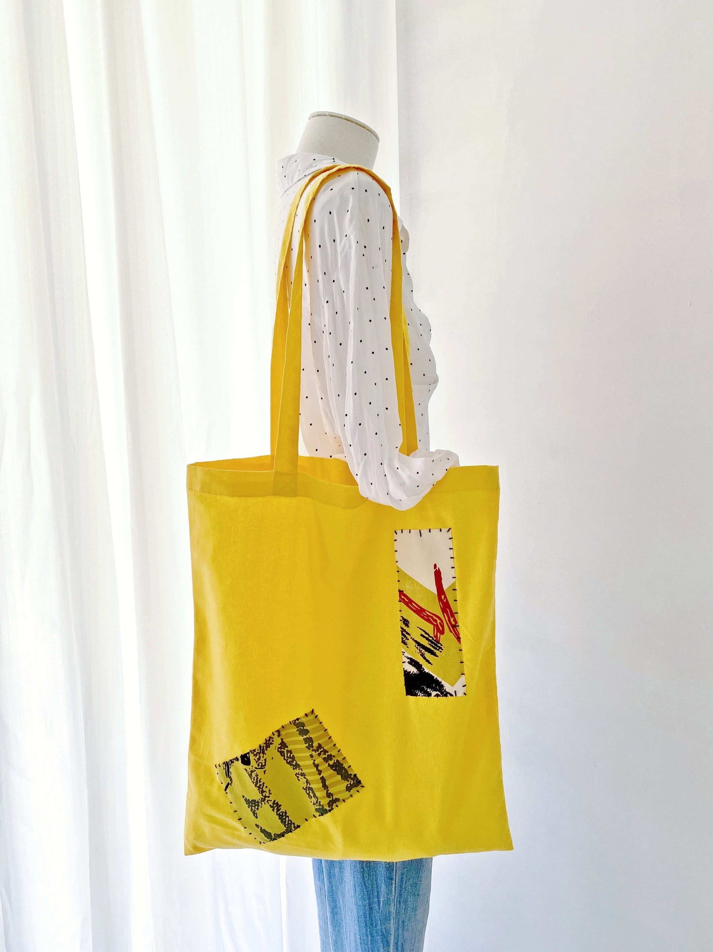 Hand-stitched patchwork on a lightweight tote, ideal for those embracing artistic fashion