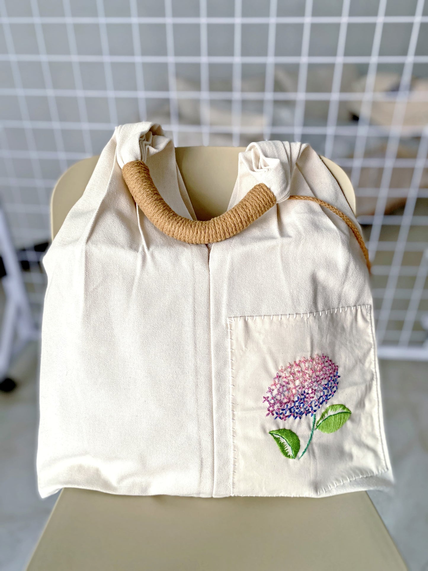 Large capacity sustainable fabric tote with artistic flower embroidery, perfect for minimalist fashion and slow living lovers.