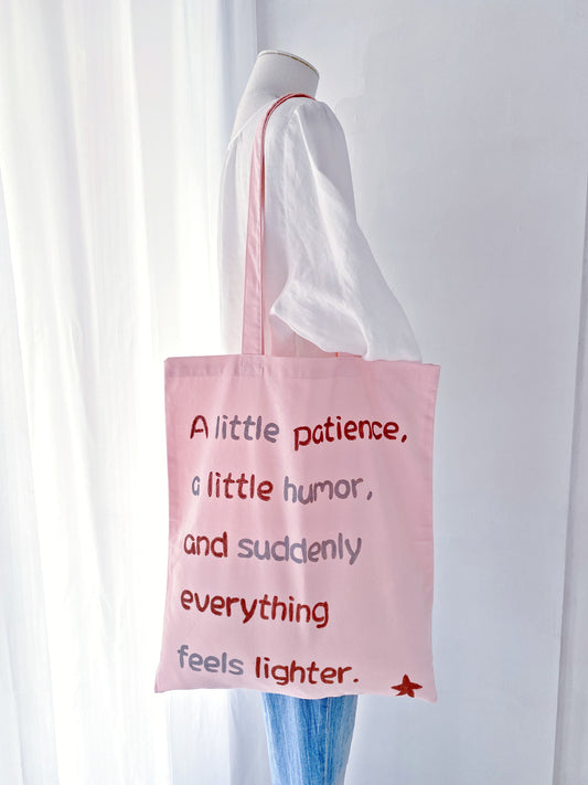 Eco-friendly lightweight tote in pink with a relaxed shape and hand-written text accent