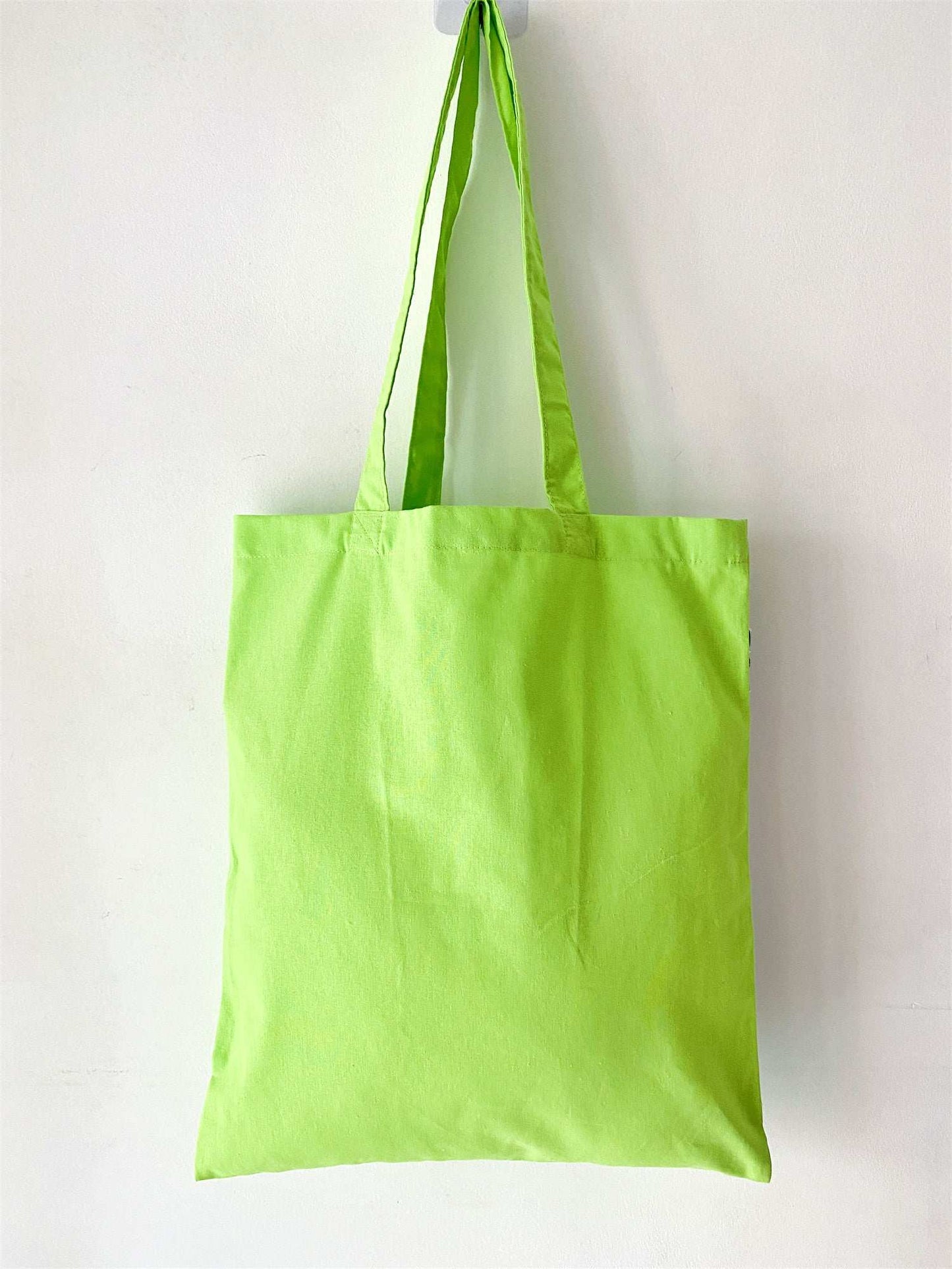 handmade patchwork detail on soft green tote