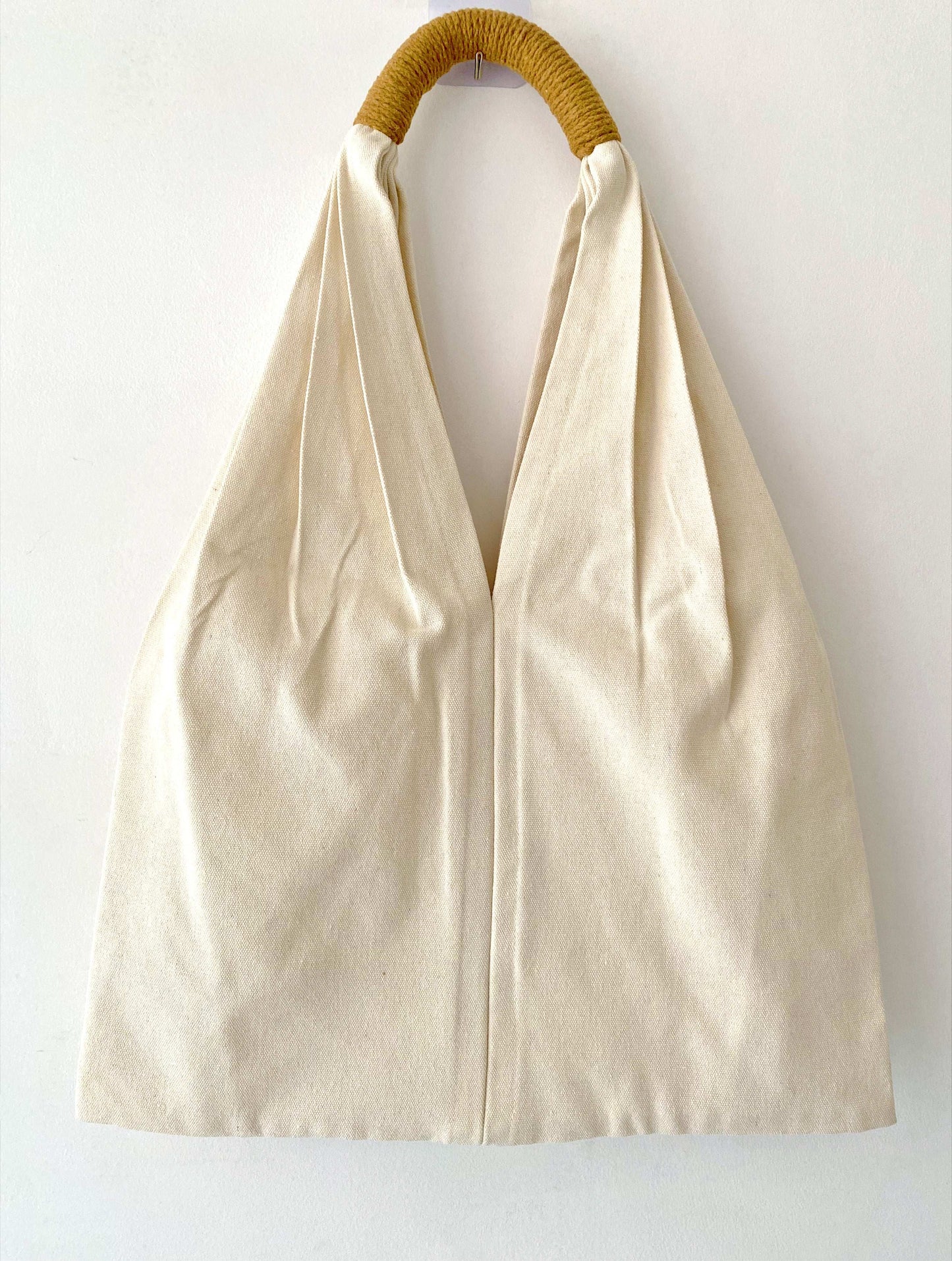 Organic material shoulder bag with hand-sewn flowers