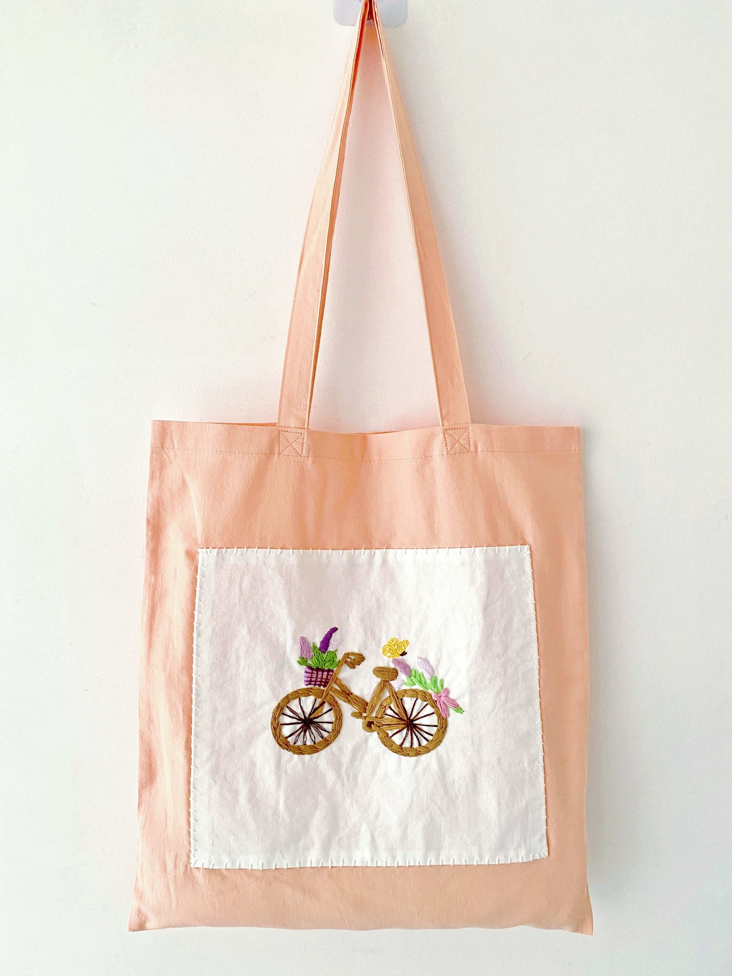Minimalist style cotton bag with unique hand-stitched bicycle flowers