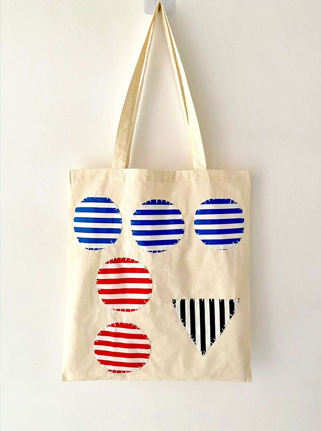 Spacious shoulder bag with stitched art