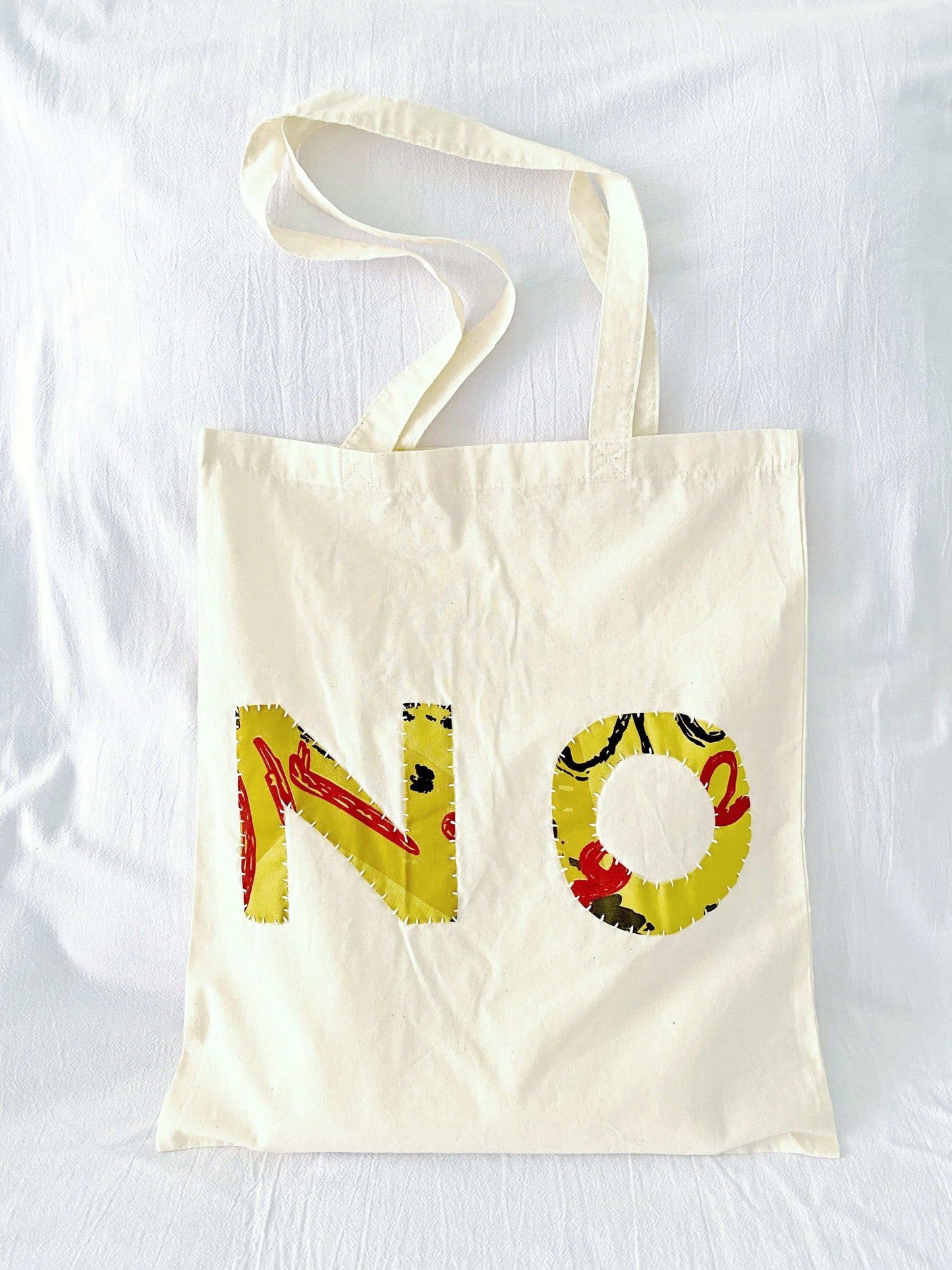 Large capacity bag with hand-stitched accents, suited for artistic and eco-minded individuals