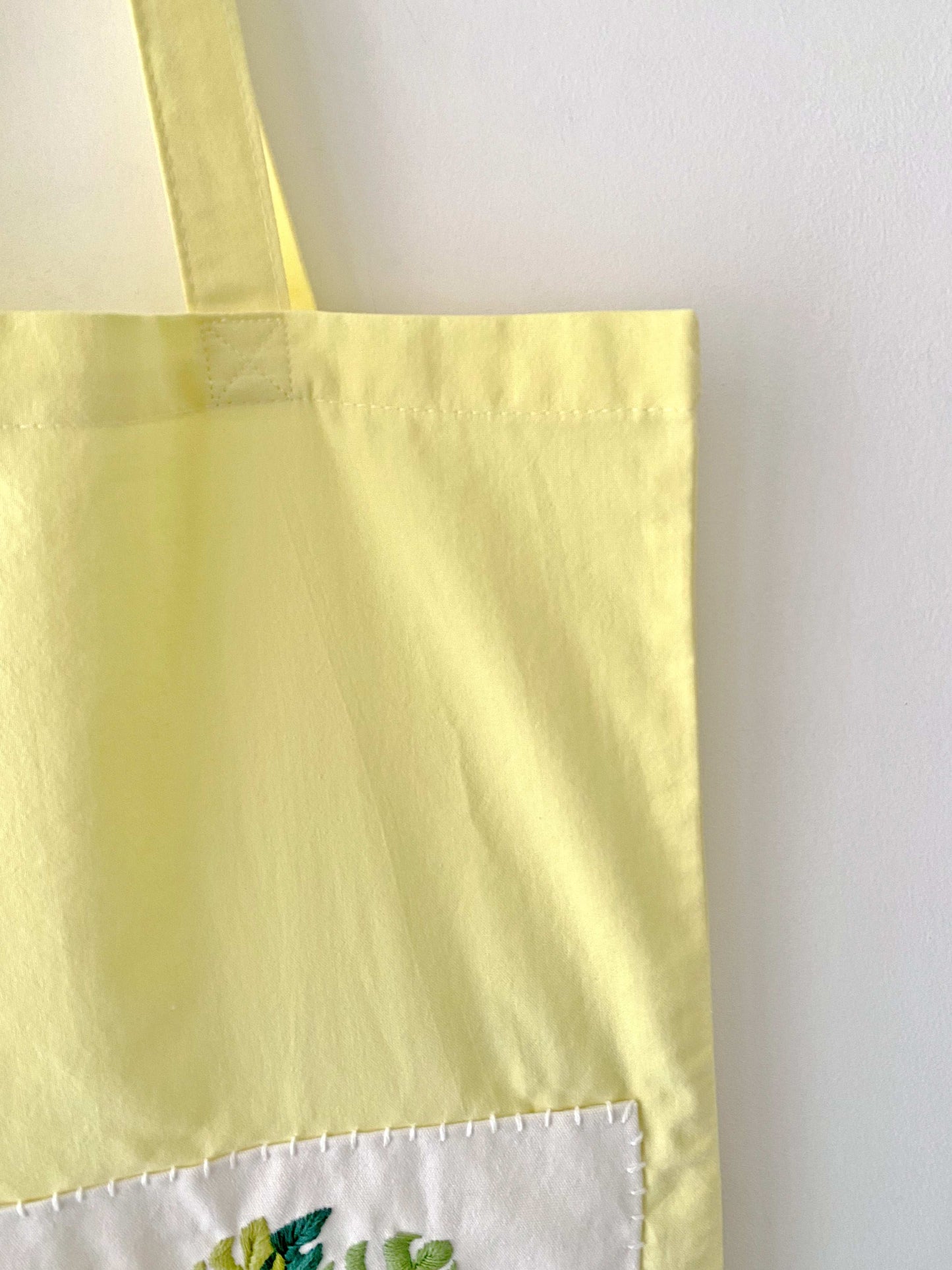 green plant hand embroidery on yellow cotton bag