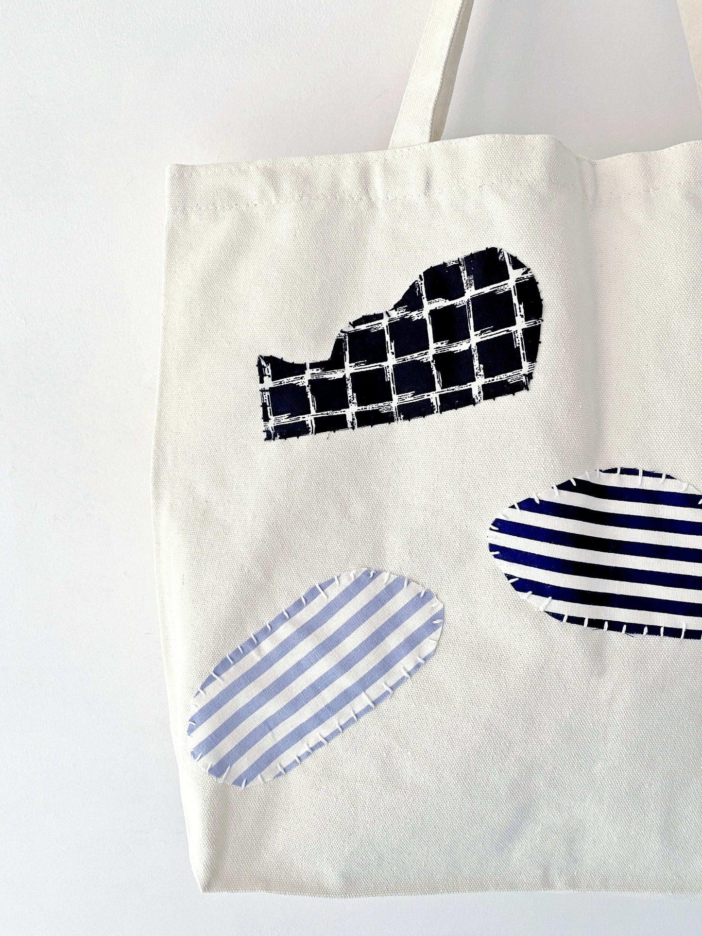 Lightweight cotton canvas tote with spacious interior and patchwork accent