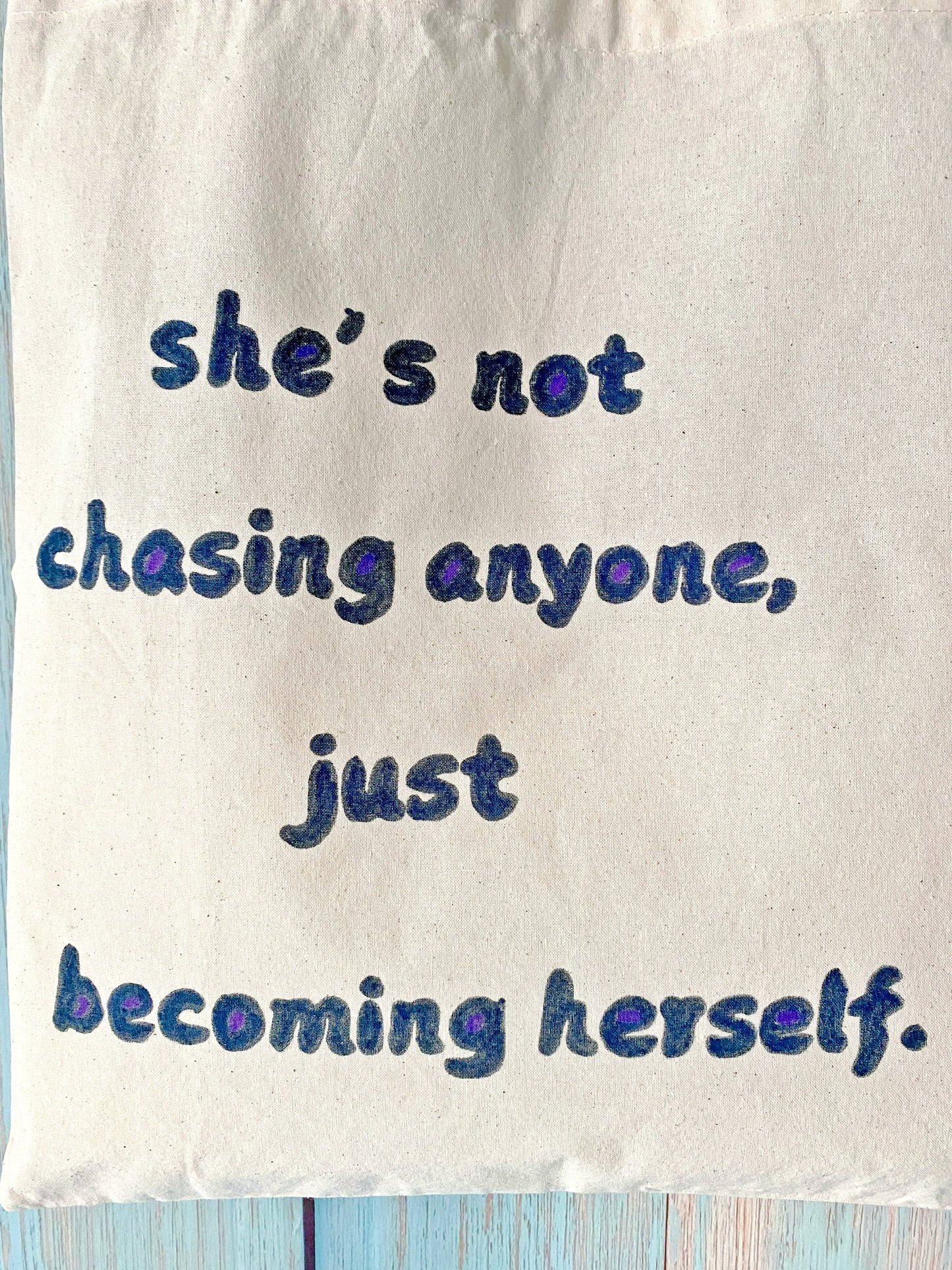 Hand-painted cotton tote with an uplifting English short phrase, offering both style and encouragement for everyday use.