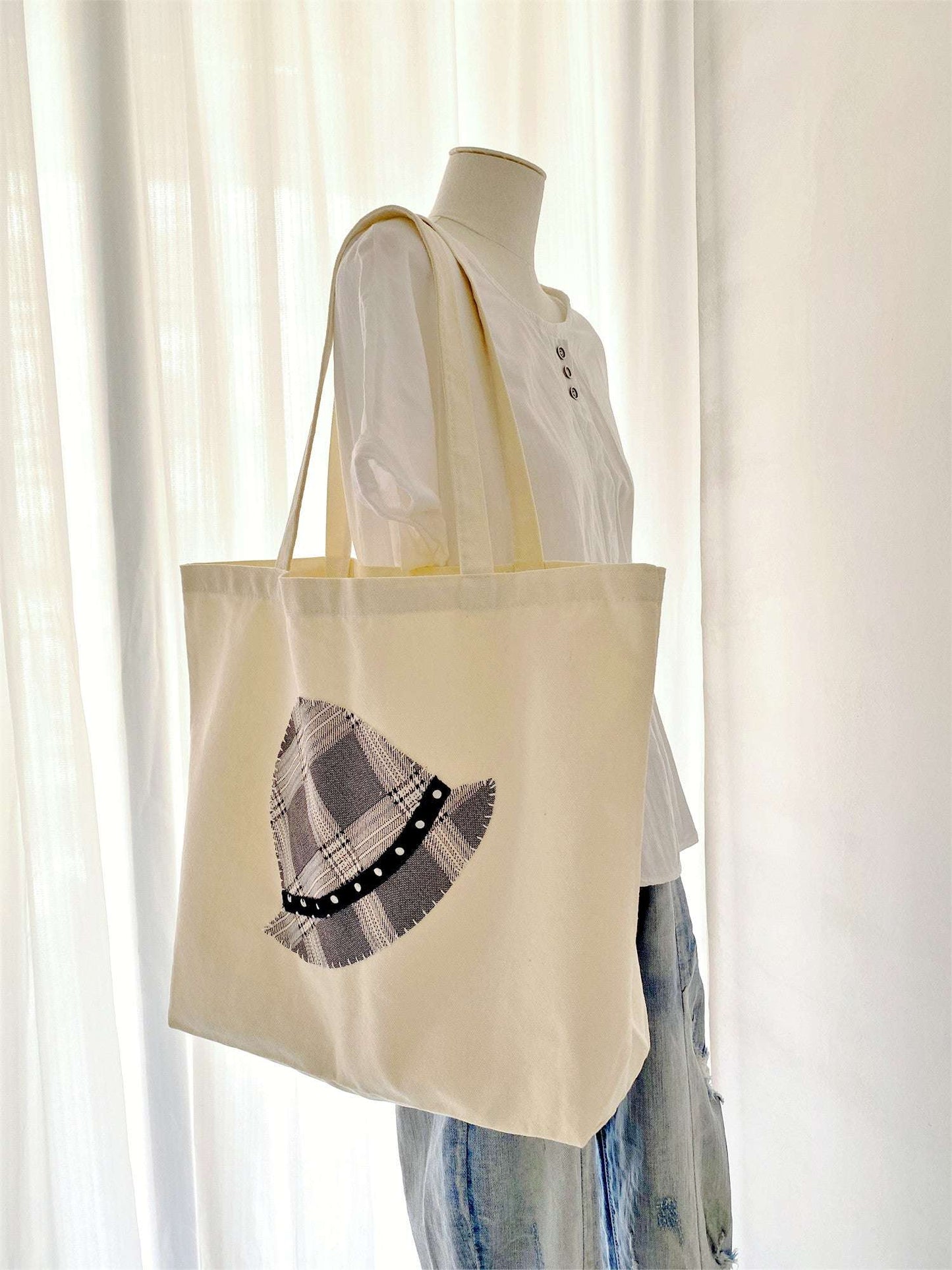 Hand-stitched gingham hat design on durable tote bag