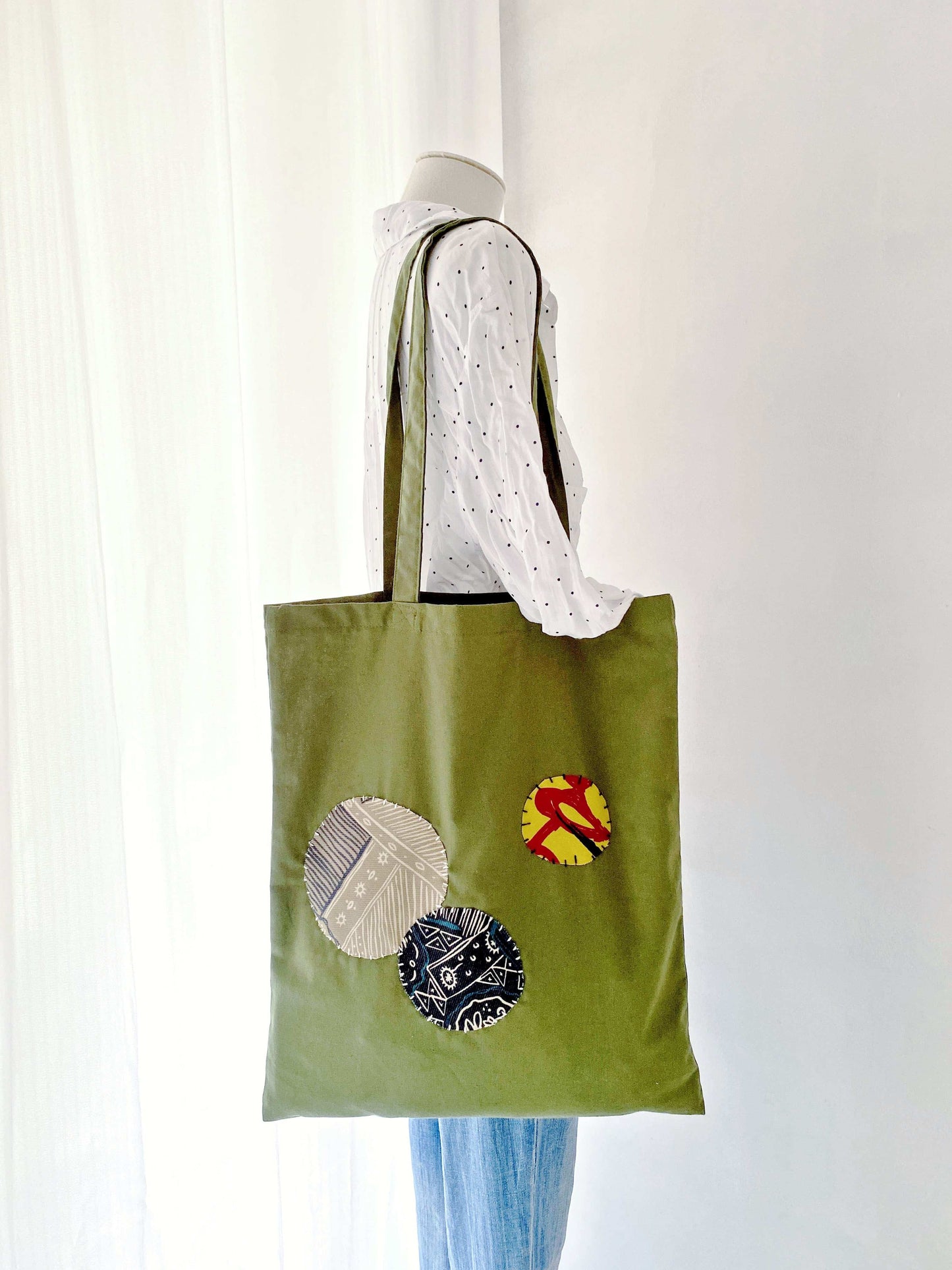 Relaxed women's shoulder tote in natural materials with intricate patchwork accents