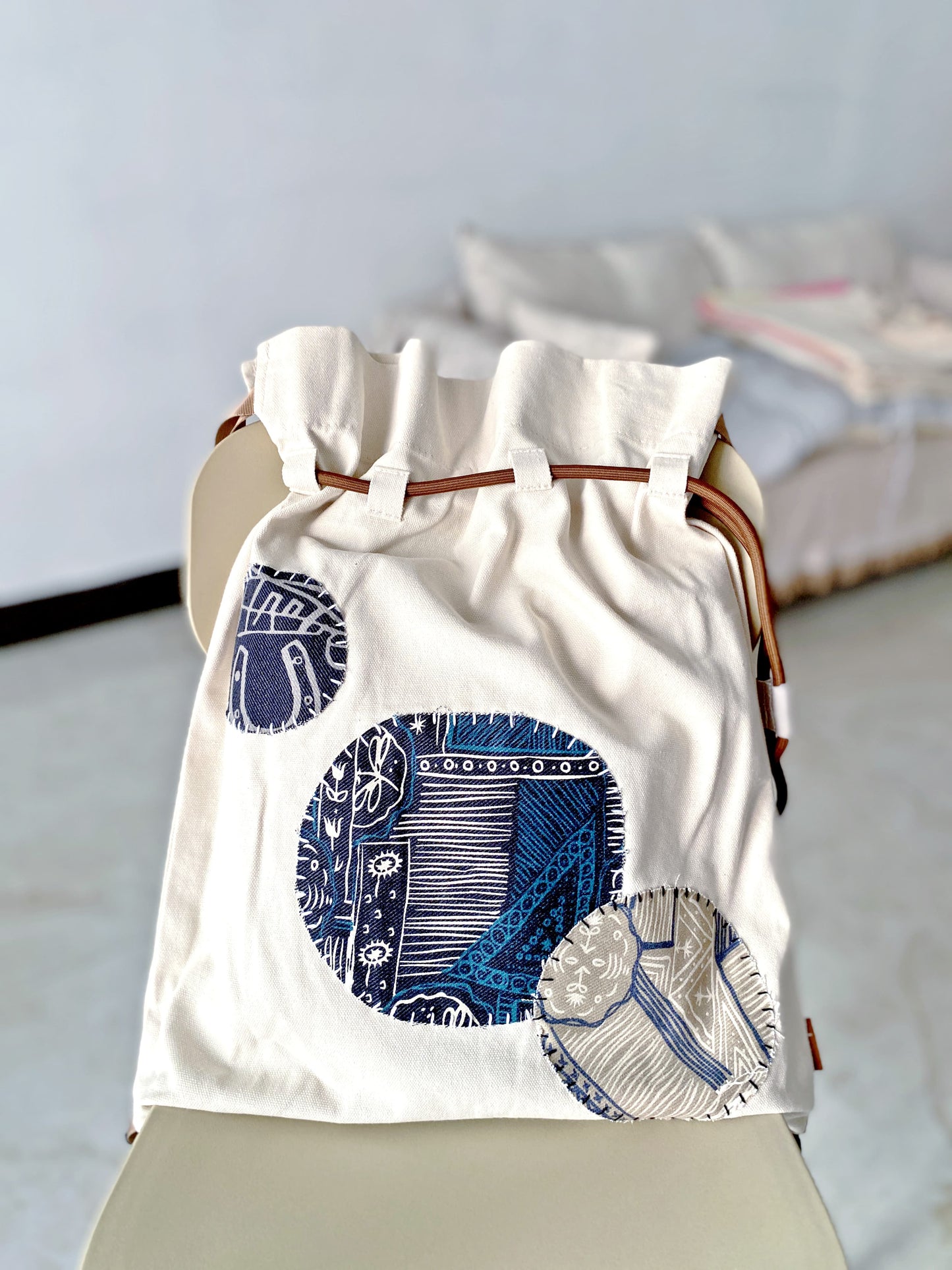 Sustainable canvas backpack gift idea with creative patchwork art, ideal for travel or school