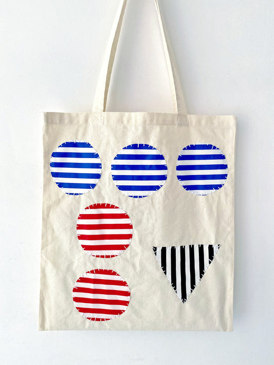 Close-up of a hand-embroidered cotton tote bag showing unique handmade details