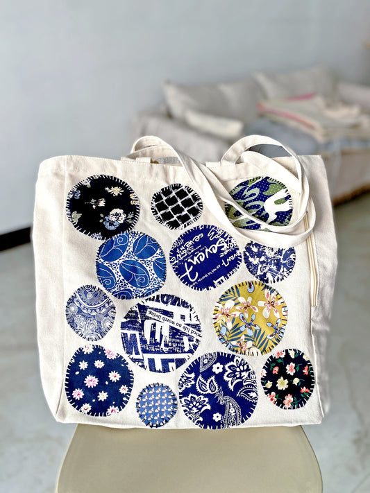 Hand-stitched patchwork bag holding books and daily essentials