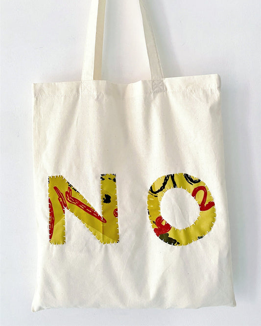 Eco-friendly canvas bag holding sketchbook and creative tools