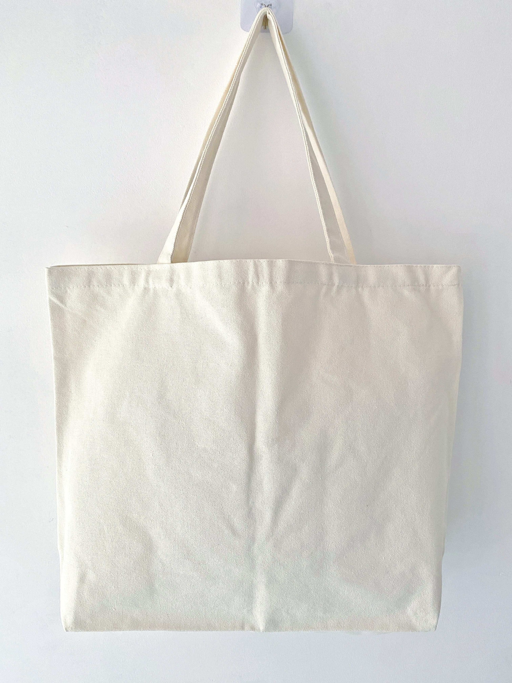 Natural materials canvas tote bag featuring hand-sewn patchwork art