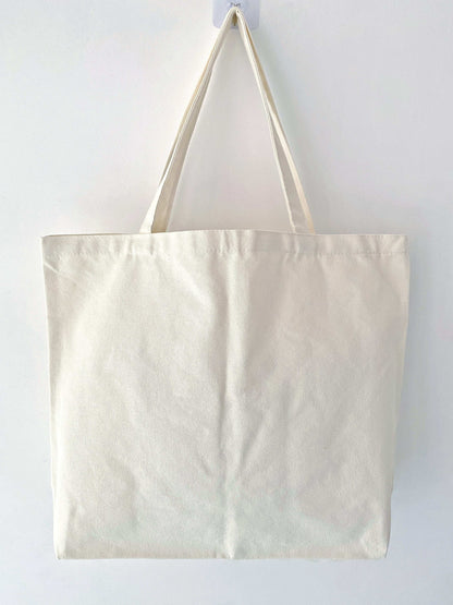Natural materials canvas tote bag featuring hand-sewn patchwork art