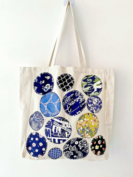 Eco-conscious tote bag showcasing intricate patchwork sewing on natural fabric for daily use