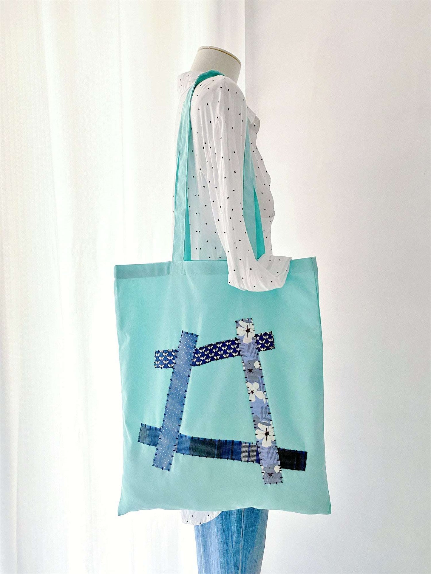 Woman strolling with a spacious cotton tote featuring unique hand-stitched patchwork for everyday ease