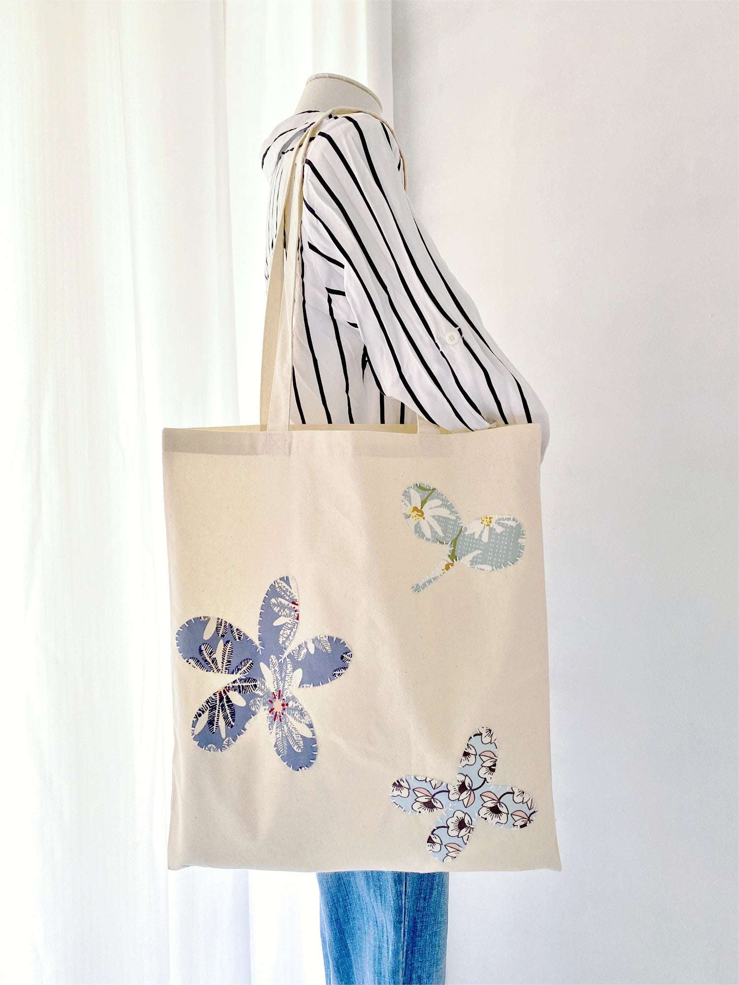 Cotton tote with hand-stitched designs for artistic personal style
