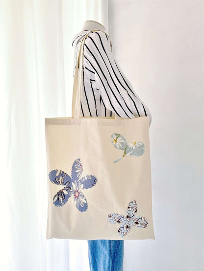 Cotton tote with hand-stitched designs for artistic personal style