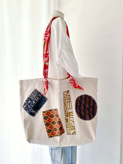 Sustainable cotton linen tote bag for women, highlighting hand-stitched motifs ideal for mindful wardrobe additions