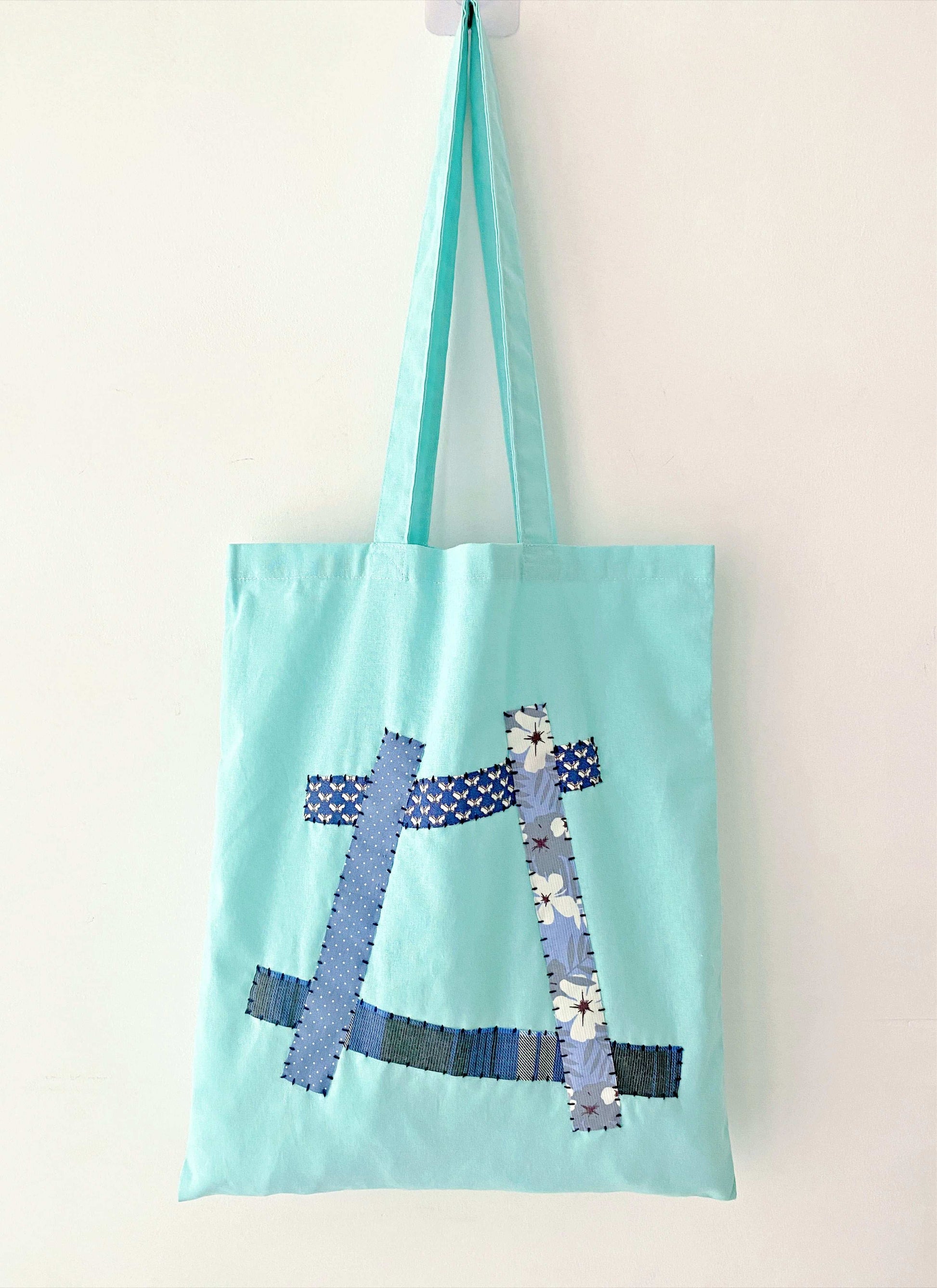 Eco-conscious shoulder bag in soft natural cotton with creative patchwork accents for relaxed outings