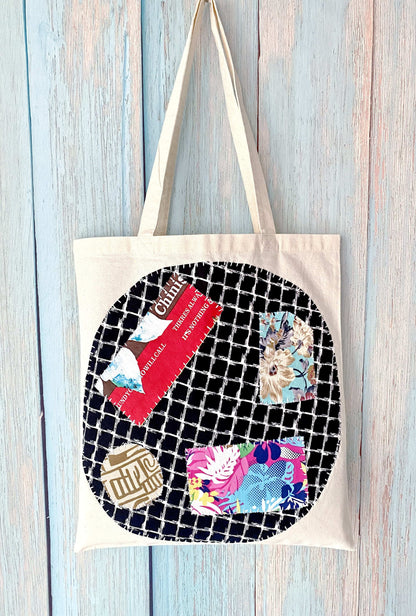 Eco canvas shoulder bag with hand-stitched patchwork art for casual daily use