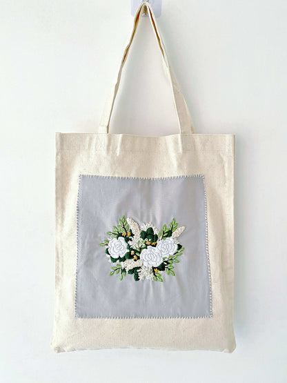 Minimalist tote with delicate hand-stitched flower patterns