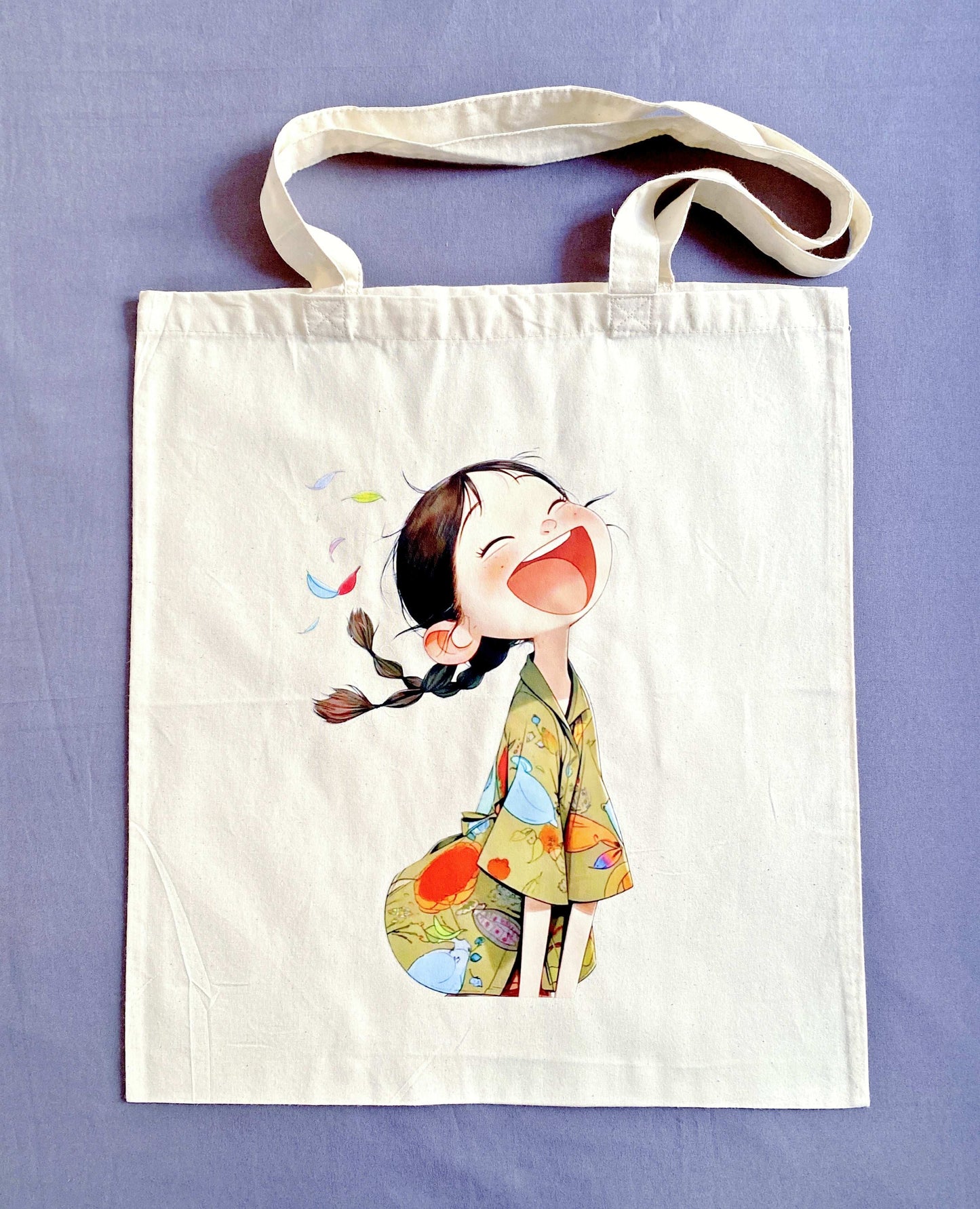 Sustainable natural fabric tote bag with a handmade print of a smiling girl, great for weekend shopping or travel.