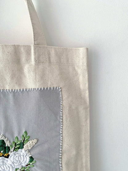 Eco-conscious cotton shoulder bag with handcrafted embroidery design