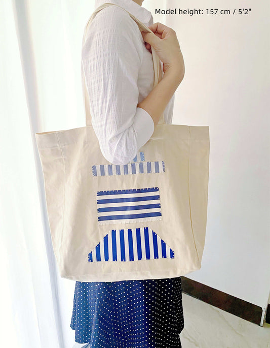 Durable eco-friendly shoulder bag made from natural cotton with artistic sewn patterns in neutral tones