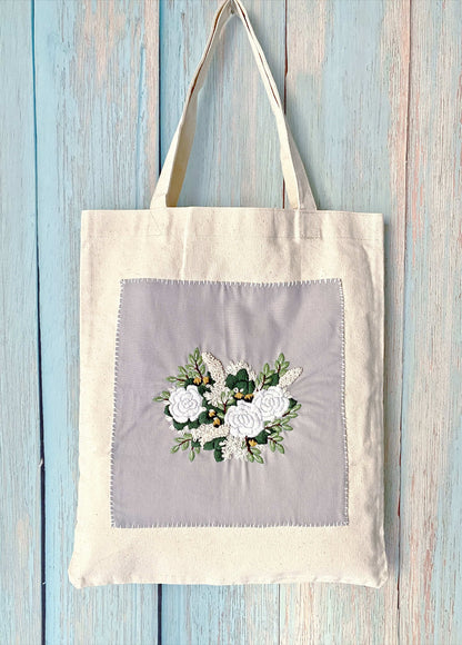 Eco-friendly canvas tote with handmade floral embroidery for sustainable everyday use