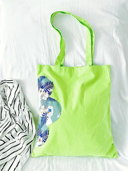 simple oversized tote bag with artistic hand-sewn charm