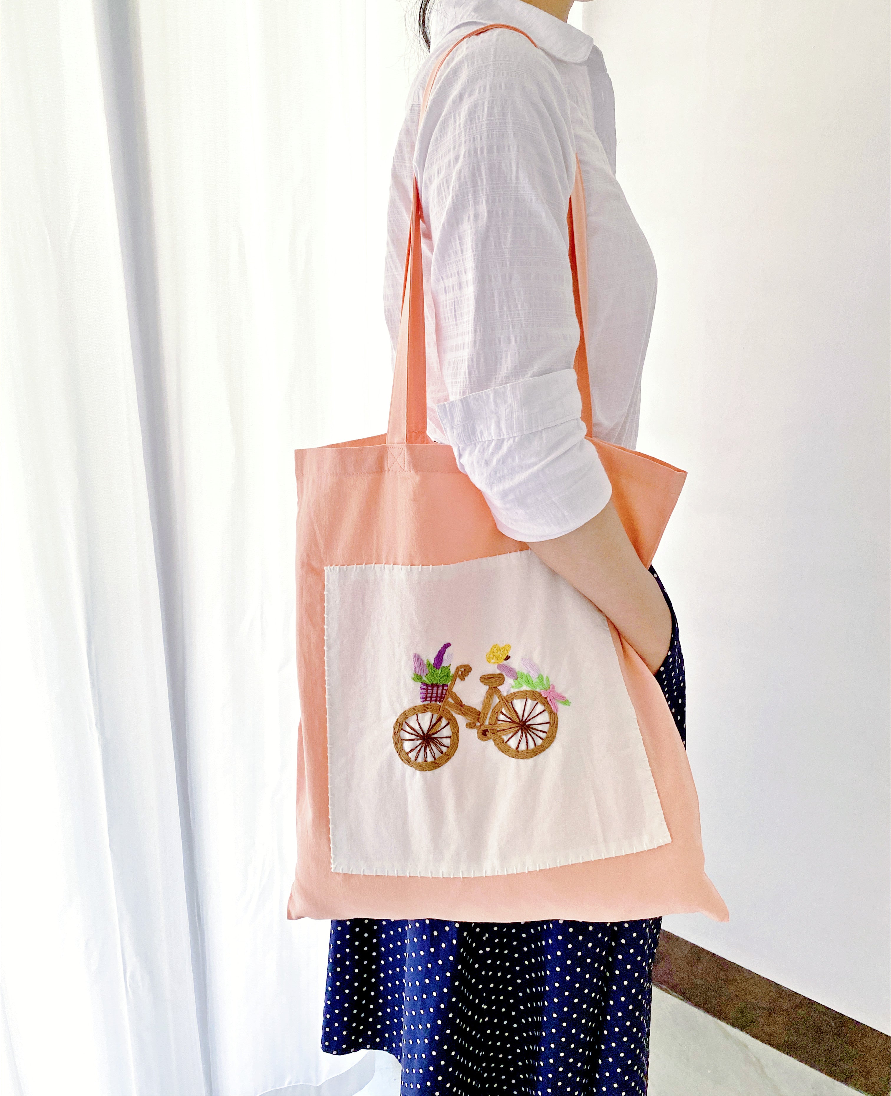 Eco-friendly cotton tote bags with embroidered floral design used as wedding gifts