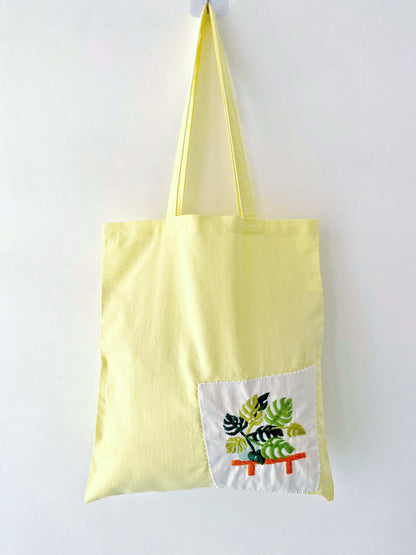 Relaxed-style cotton shoulder tote with hand-stitched flowers