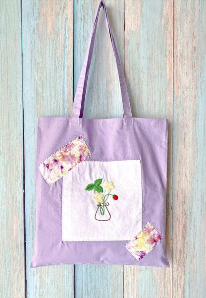 Elegant sustainable cotton tote bag with handcrafted floral embroidery, perfect as a thoughtful gift for any occasion.