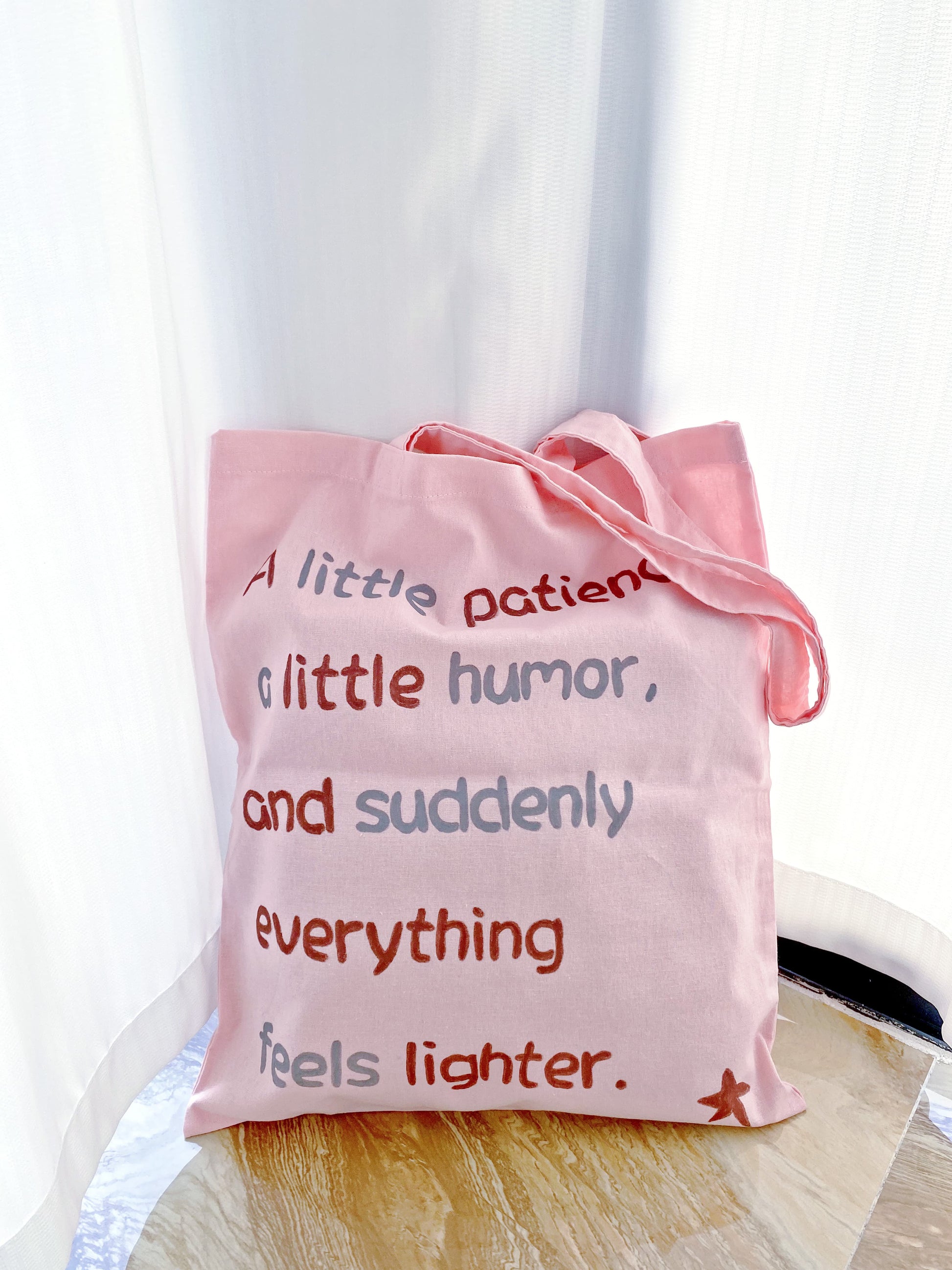 Cotton shoulder tote in soft blush pink with a relaxed drape and handwritten accent