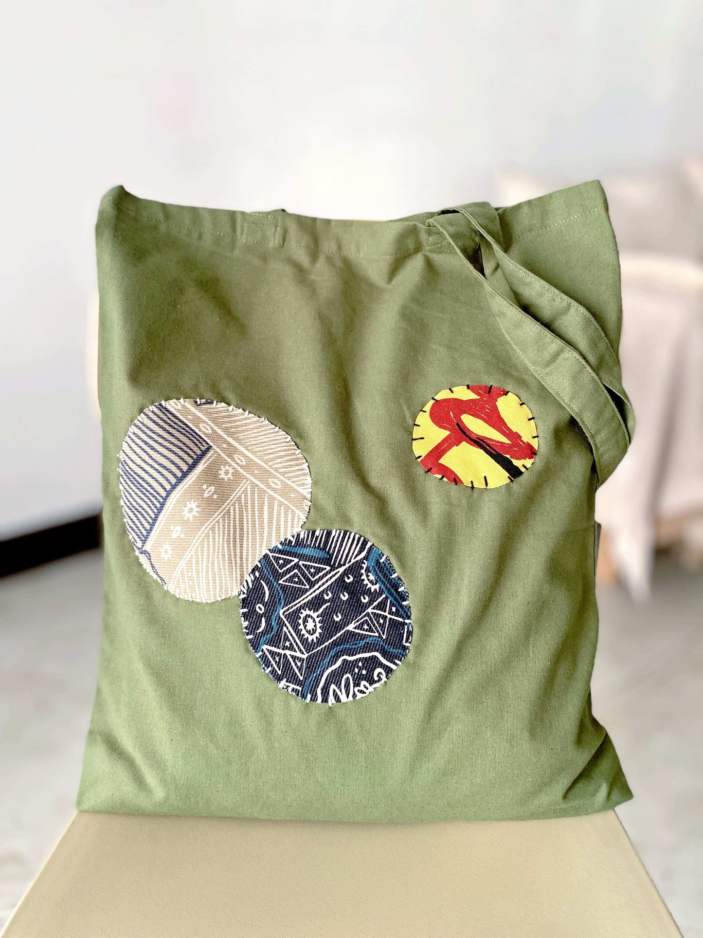 Natural cotton tote with unique hand-stitched patchwork, perfect for sustainable fashion lovers