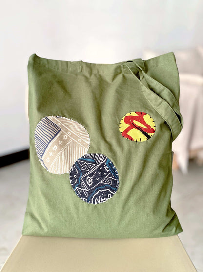 Natural cotton tote with unique hand-stitched patchwork, perfect for sustainable fashion lovers