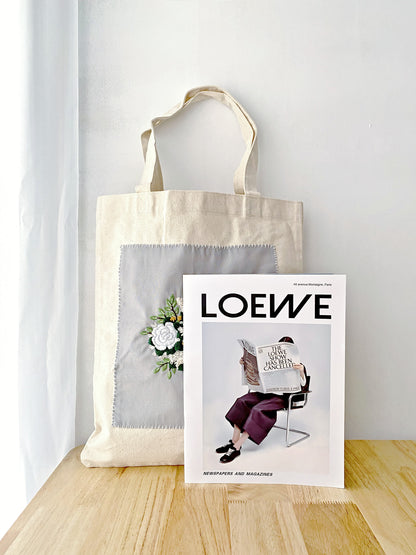 Creative women’s canvas tote bag with hand-embroidered floral design