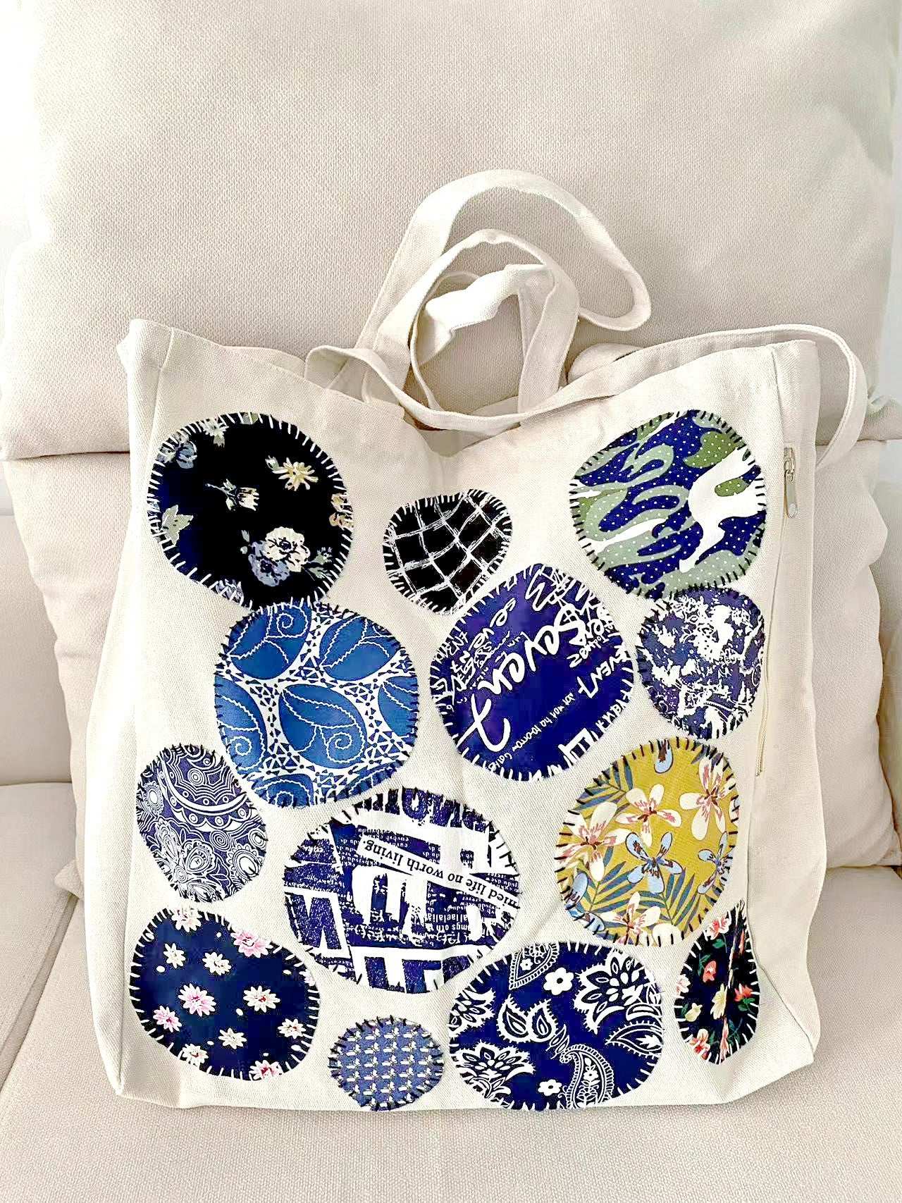 Sturdy cotton shoulder bag with unique hand-stitched designs, embracing slow fashion principles