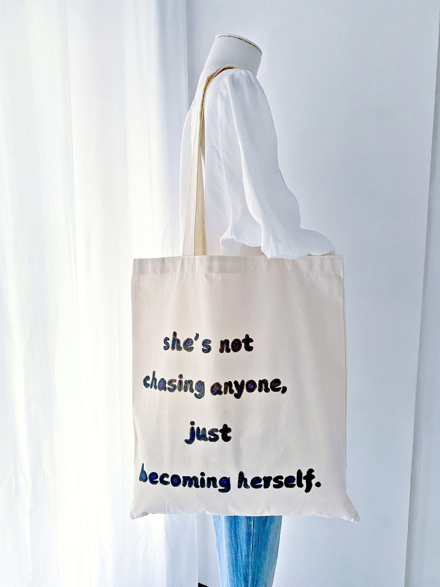 Stylish and durable cotton tote featuring a hand-painted motivational phrase, designed for eco-conscious shoppers.