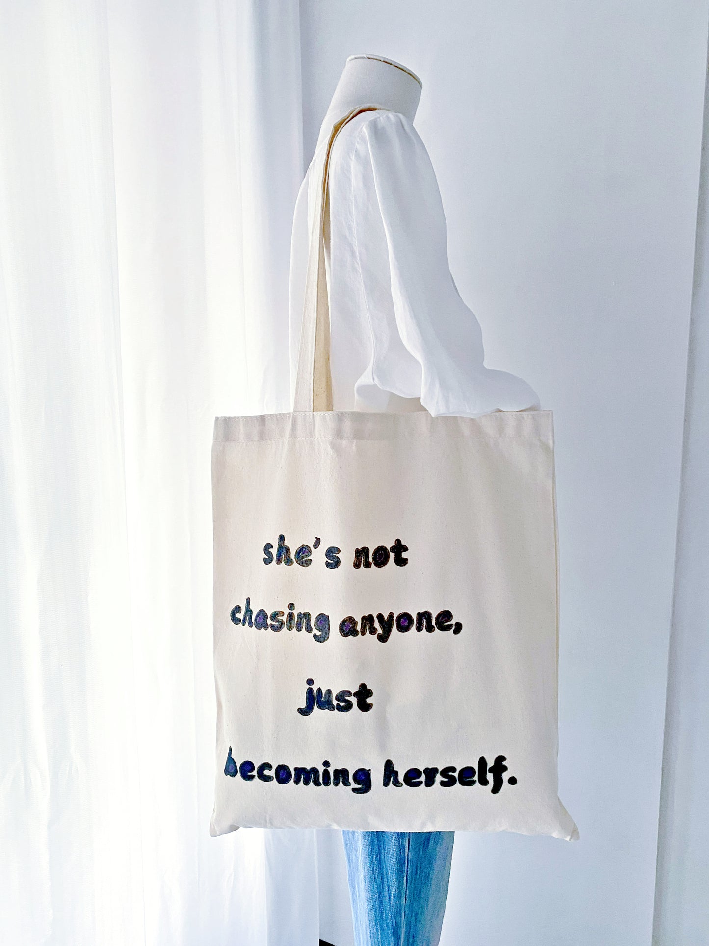 Stylish and durable cotton tote featuring a hand-painted motivational phrase, designed for eco-conscious shoppers.