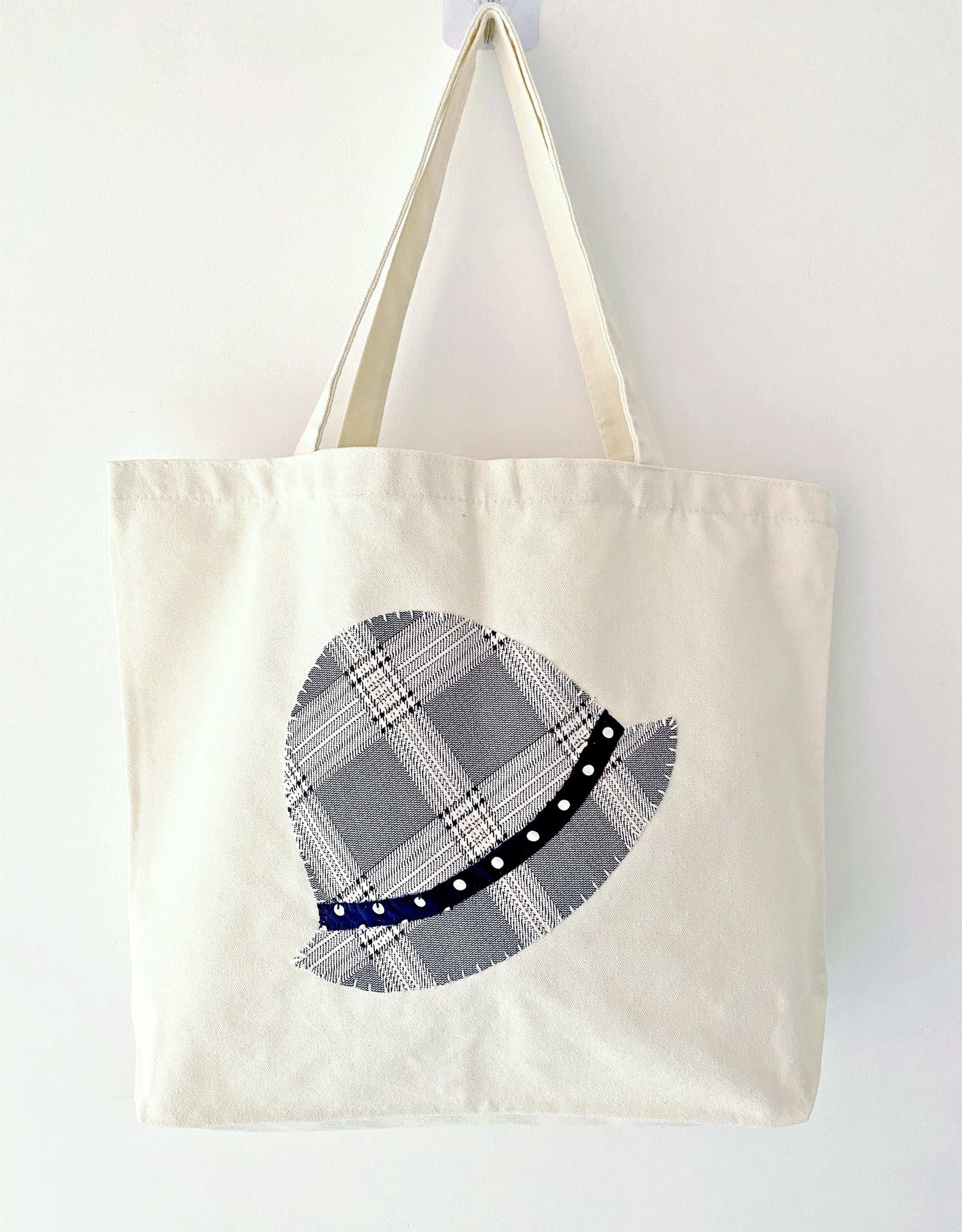 Minimalist shoulder bag made of natural cotton canvas with stitched patchwork