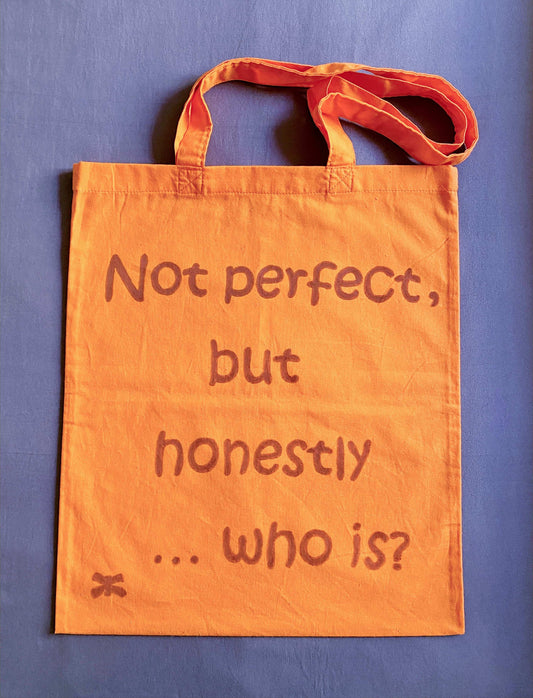 orange cotton tote featuring a handwritten English text detail