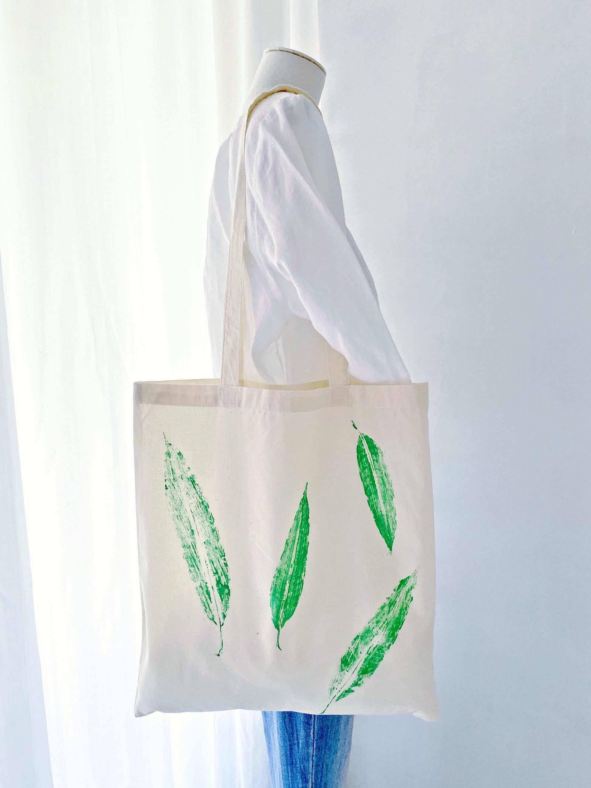natural material tote with leafy artwork